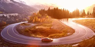 car-twisting-road-sunset