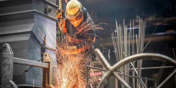 Man-working-sparks-fire-heat