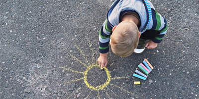 Kid-drawing-sun-concrete-sidewalk-chalk-pigment-dispersions