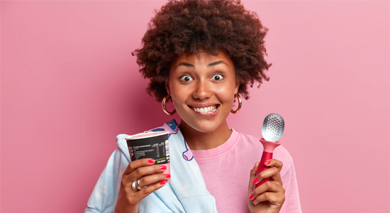 woman-holds-ice-cream-and-spoons