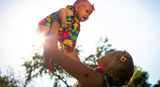 mother-holding-baby-outside