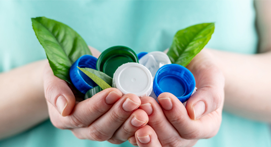 plastic-bottles-caps-in-hand-with-leaves
