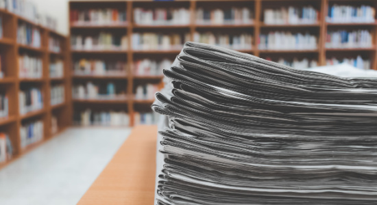 stack-of-newspapers-in-library