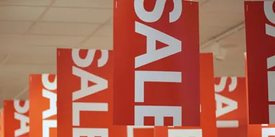 sale-signs-from-ceiling-of-department-store