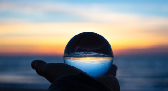 snow-globe-held-in-hand-looking-like-sunset-beach