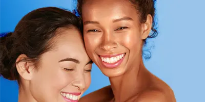 two-women-smiling-wearing-makeup