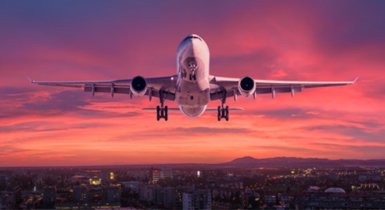 airplane-flying-in-sunset