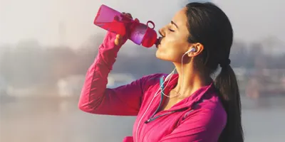 woman-drinks-from-pink-tumbler-wearing-pink-outfit