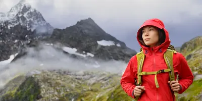 woman-red-jacket-walking-in-mountains