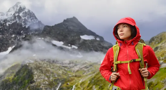 woman-red-jacket-walking-in-mountains