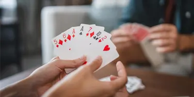 holding-a-deck-of-face-cards-poker